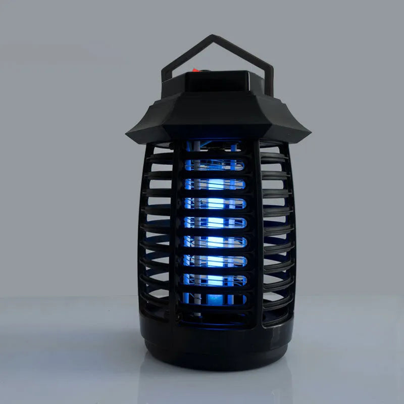 Black aromatherapy mosquito lamp insect killer with choice of international plug styles on a table.