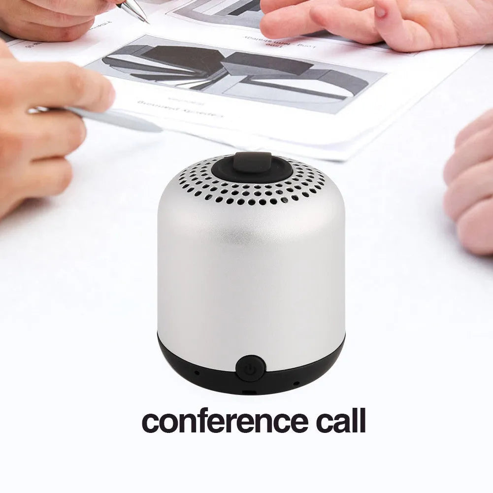 Hieha XQ11 cylindrical mini portable Bluetooth speaker in silver colour on a table.