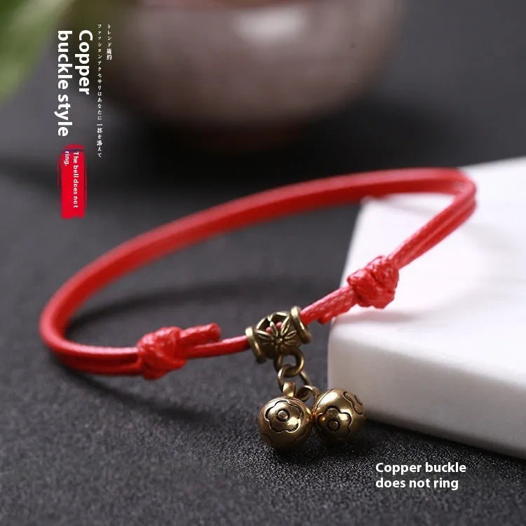 Small dog collar made of nylon rope with a brass bell, shown in black colour.