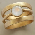 Gold-plated titanium steel ring with hollow micro-inlaid white chalcedony in geometric design