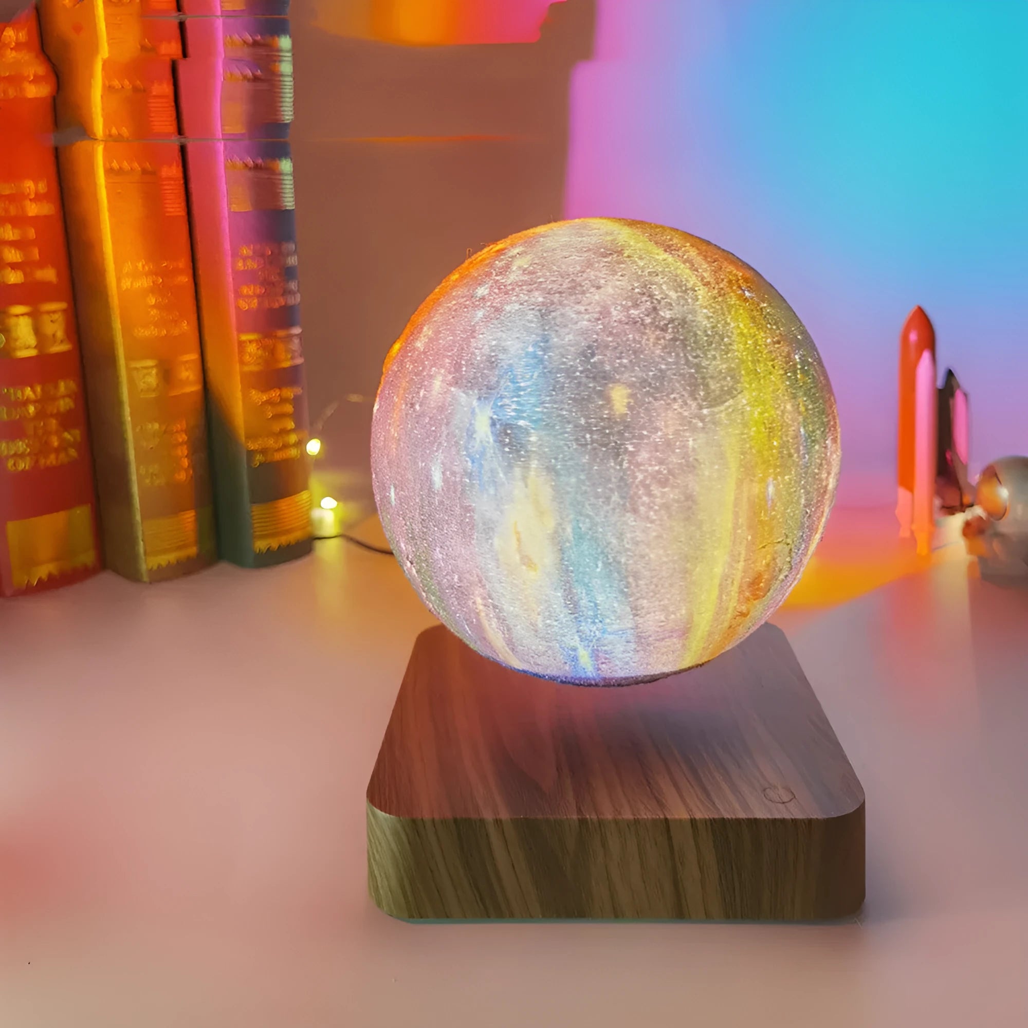 Magnetic levitation galaxy decorative light with rotating moon lamp above walnut-coloured base