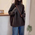 Red women's loose turtleneck sweater with a textured curling pile collar, shown in a casual setting.