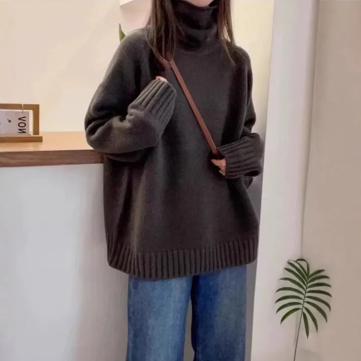 Red women's loose turtleneck sweater with a textured curling pile collar, shown in a casual setting.