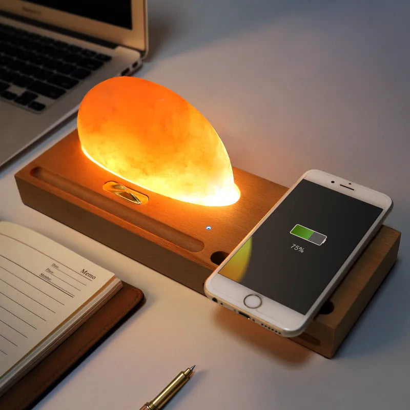 Sunrise Oriental table lamp with natural salt shade on wood base, showing wireless phone charging.