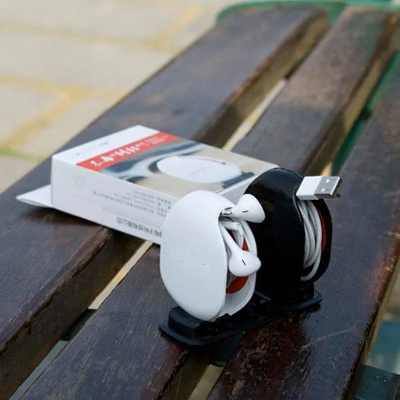Automatic earphone cable winder retractor in PC ABS plastic, showing compact size and multiple colour options.