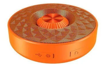 Compact black/orange/silver white portable Bluetooth speaker on a surface, showing its 360-degree grille.