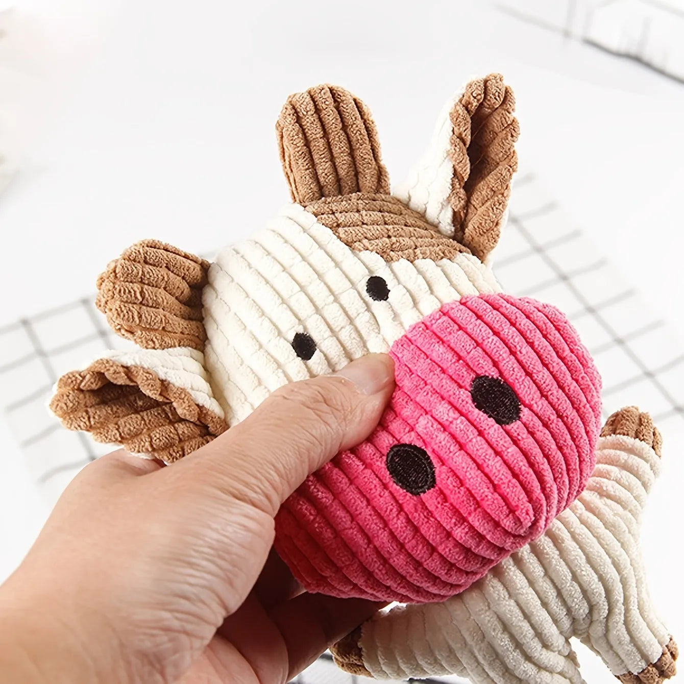 Animal-shaped plush dog chew toy with squeaker, available in multiple colours.