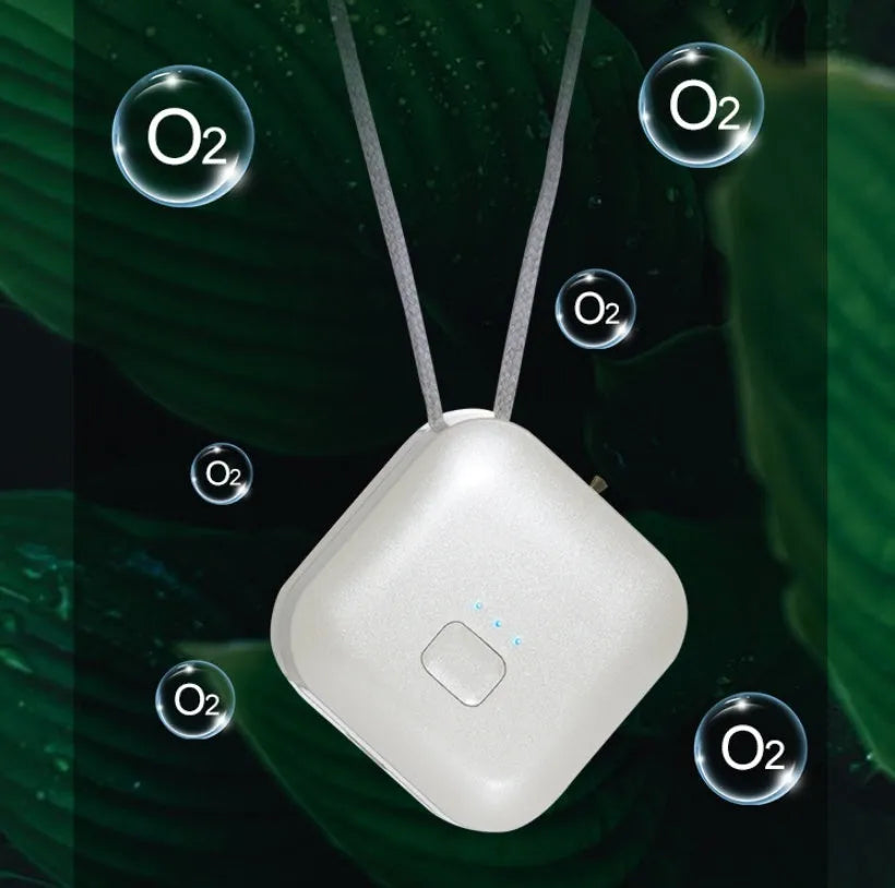 Pink and blue wearable USB air purifier necklace shown on a person, with dimensions 1.5 by 5.7 by 4.5 cm.