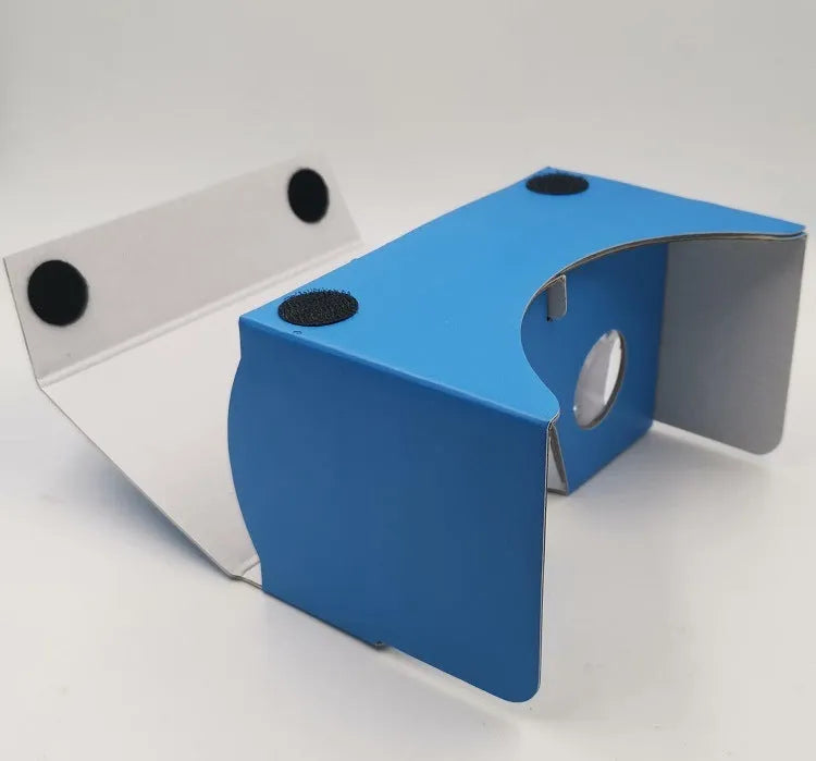 Pink and white VR cardboard glasses viewer for smartphones with adjustable head strap.