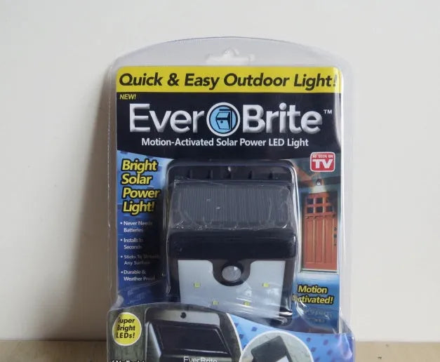 Set of four white solar security lights with motion sensors and adjustable solar panels for outdoor mounting