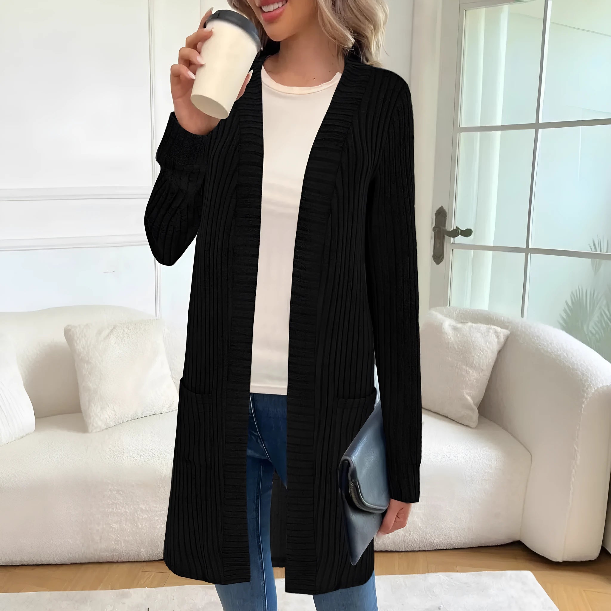 Long sleeve loose fit knitted cardigan jacket with pockets in polyester fabric.
