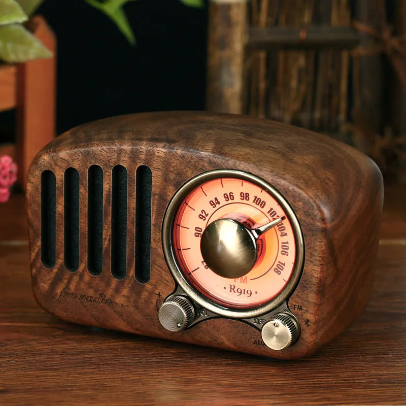 Compact retro wooden Bluetooth mini speaker in cherry wood finish showing front grille and wood grain.