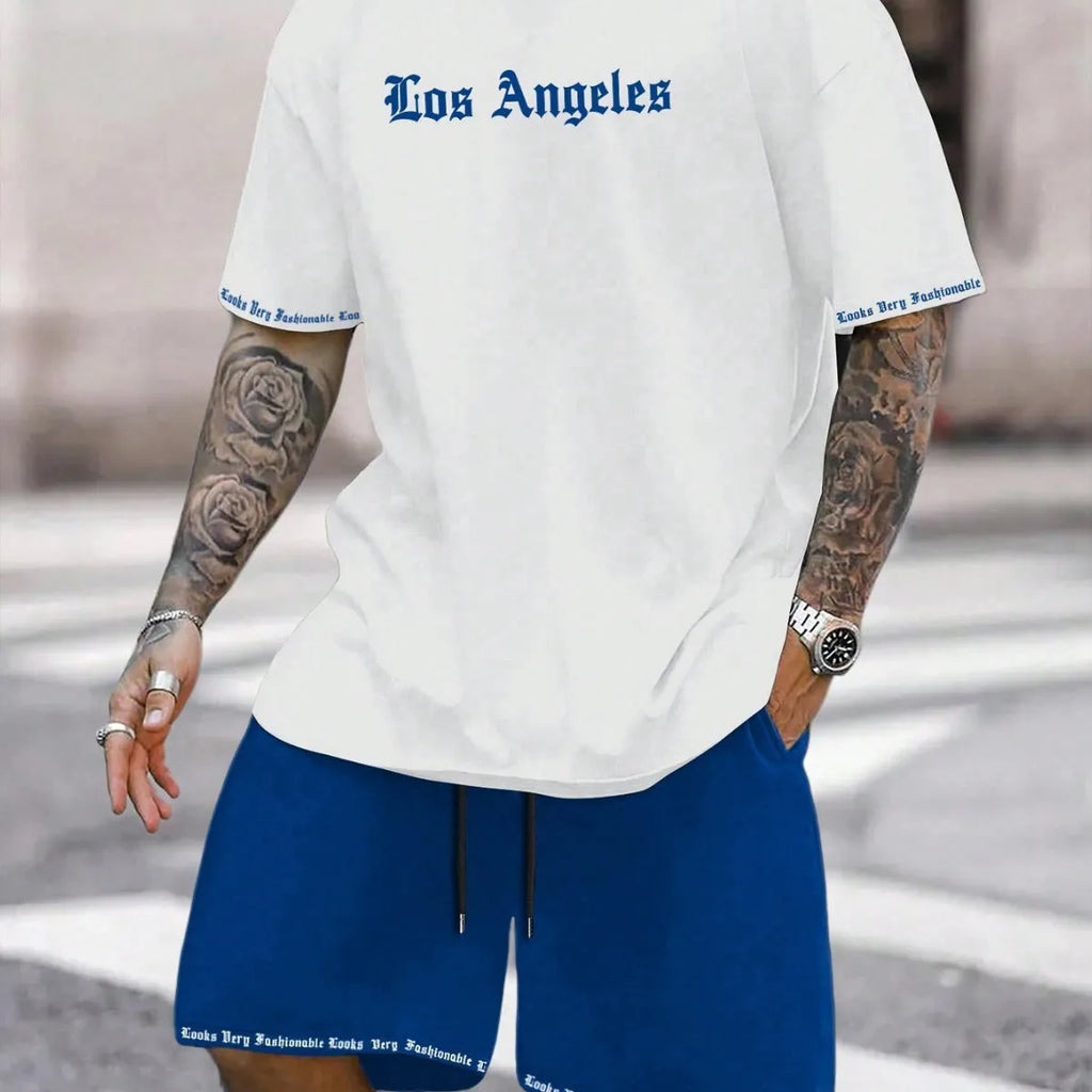Man wearing a grey short-sleeve top and matching shorts from a sports co-ord set.