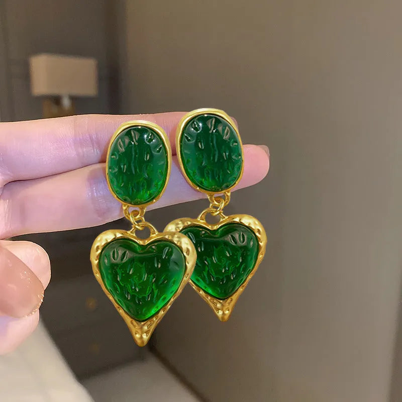 Silver pleated heart-shaped stud earrings in purple, red, green, and yellow/white colours.