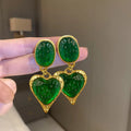 Silver pleated heart-shaped stud earrings in purple, red, green, and yellow/white colours.