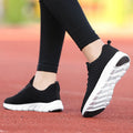 Women's running shoes with Fly Knit woven upper in Black, Pink, or White colour options