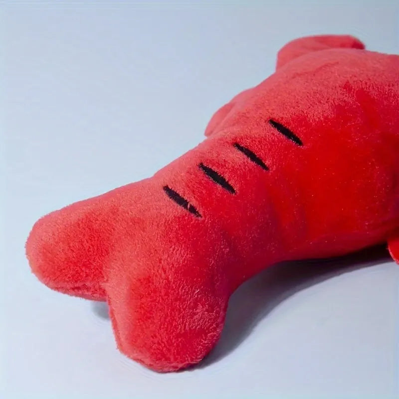 Red lobster shaped squeaky dog toy with soft plush material measuring 12.5cm length