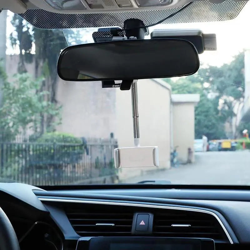 Black mobile phone bracket mounted on car rearview mirror holding smartphone