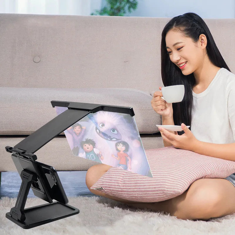 Black L20 split mobile phone screen magnifier with separate support bracket on a table.
