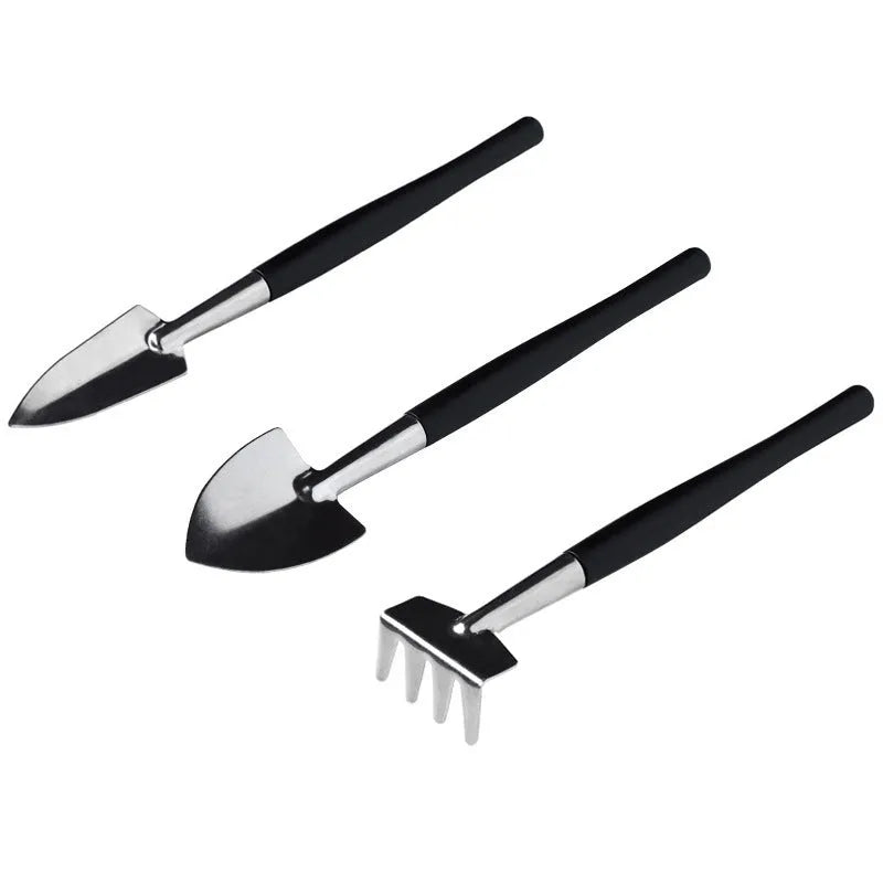 16-piece black succulent garden tool set with cushion, showing scissors, tweezers, shovels, rake, watering bottles, and air blower.