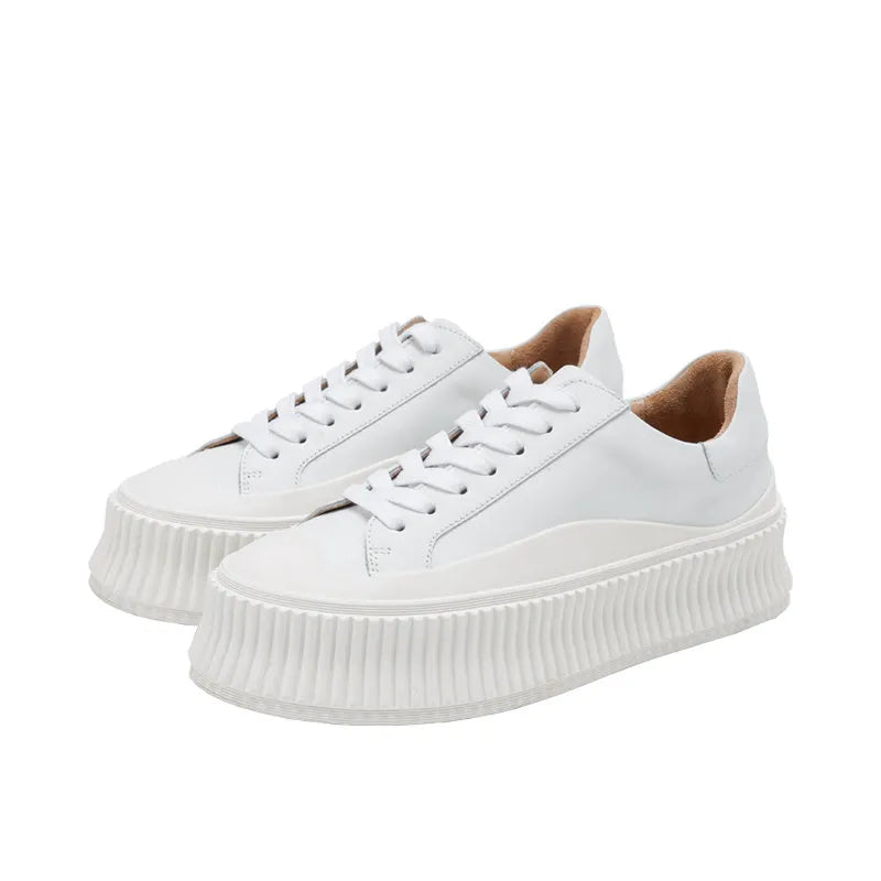 Women's suede platform sneakers with thick rubber soles and cross binding detail in black, white and white-black colour options