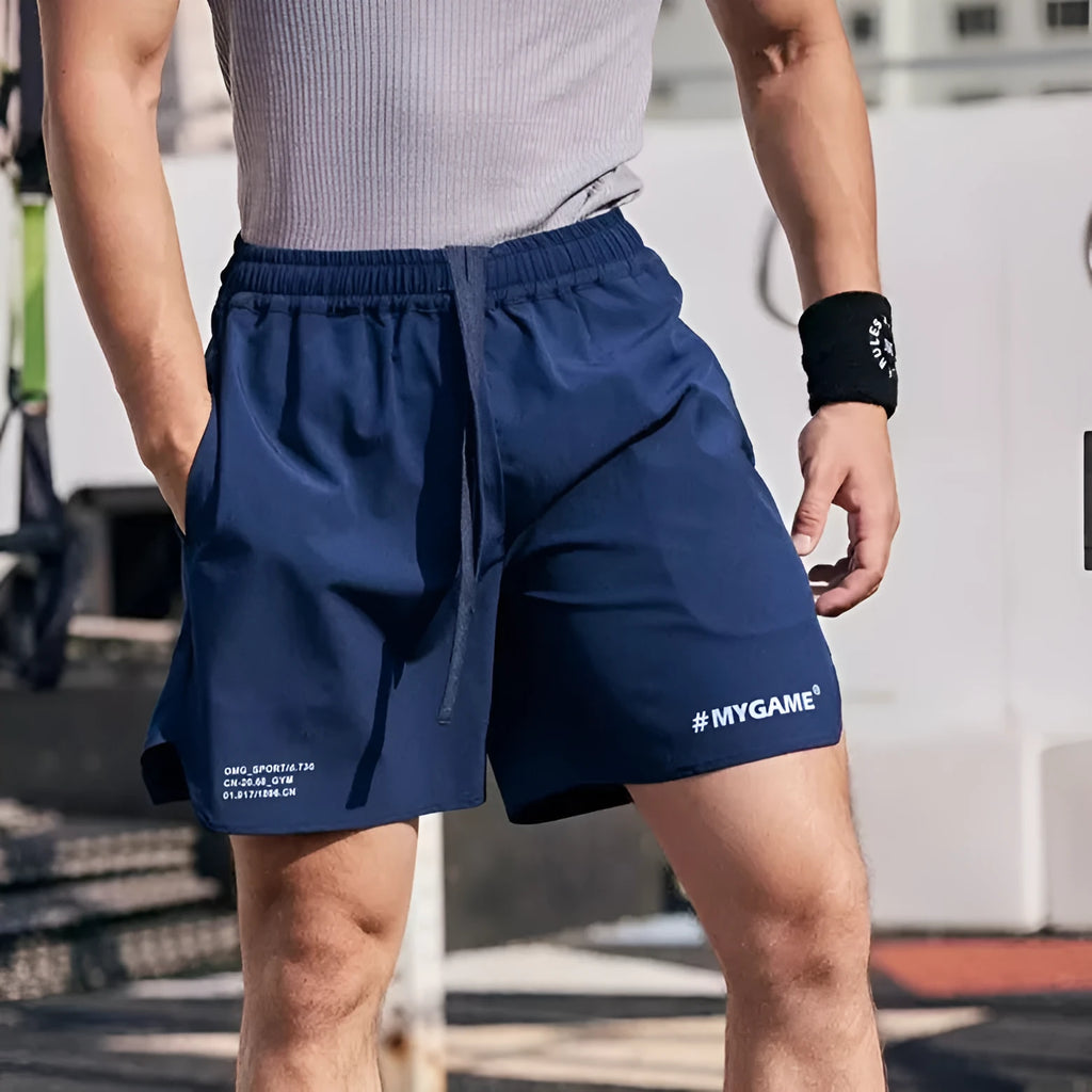 Men's grey fitness shorts showing short-length design with elastic waistband for training and athletic wear