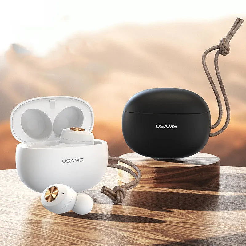 Wireless Bluetooth mini TWS earbuds and charging case in black, shown for scale.