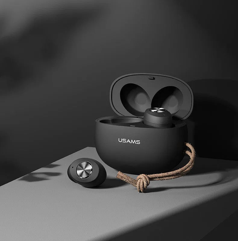Wireless Bluetooth mini TWS earbuds and charging case in black, shown for scale.