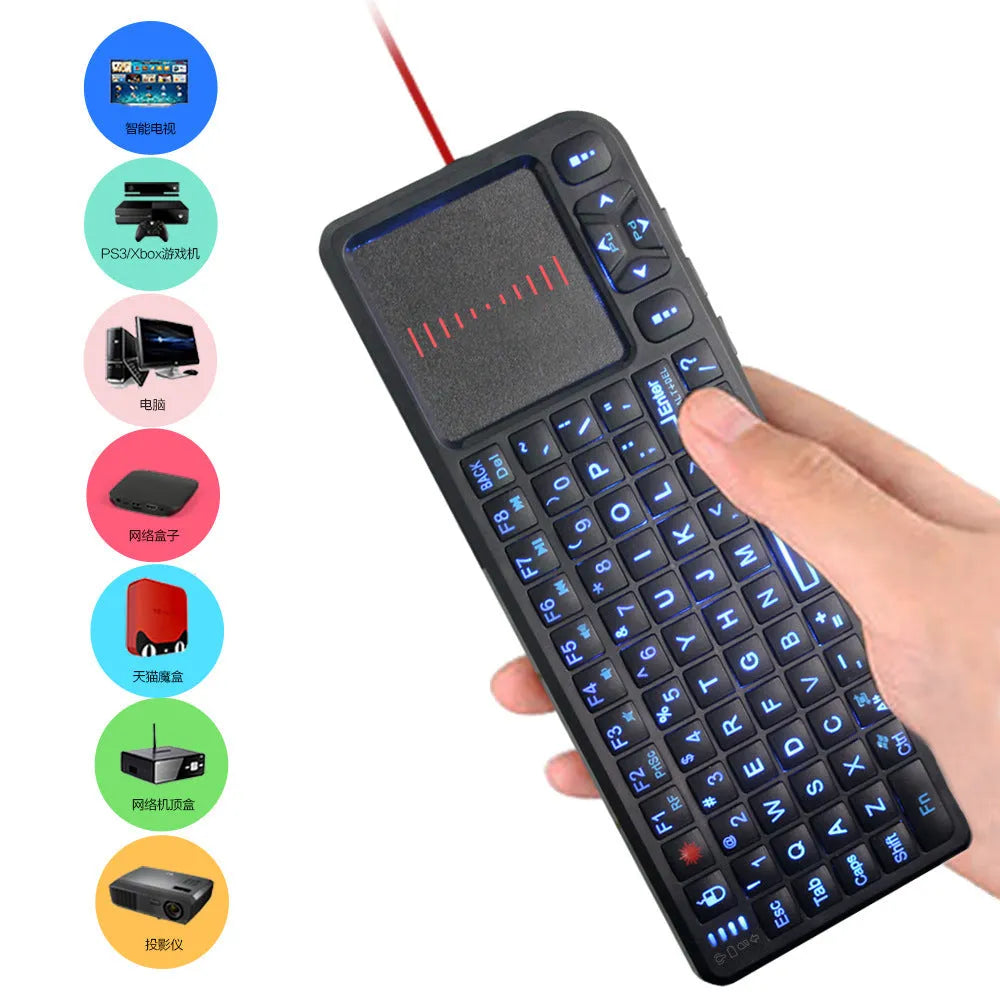 Black wireless mini keyboard with touch screen and matching optical mouse on a desk