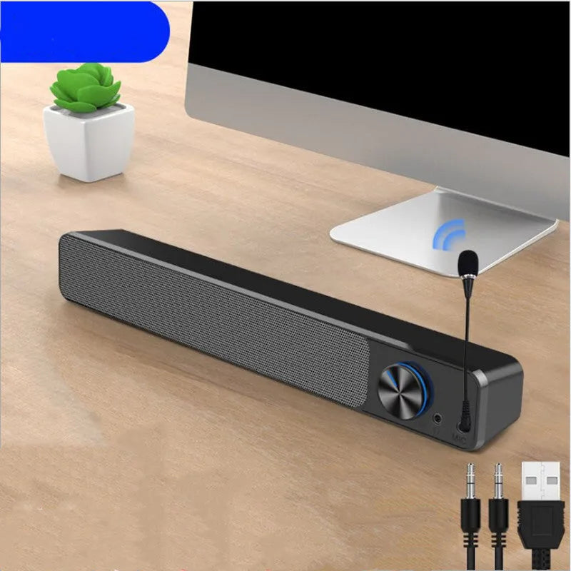 Black and white wired desktop computer speakers with ABS PC casing on a desk