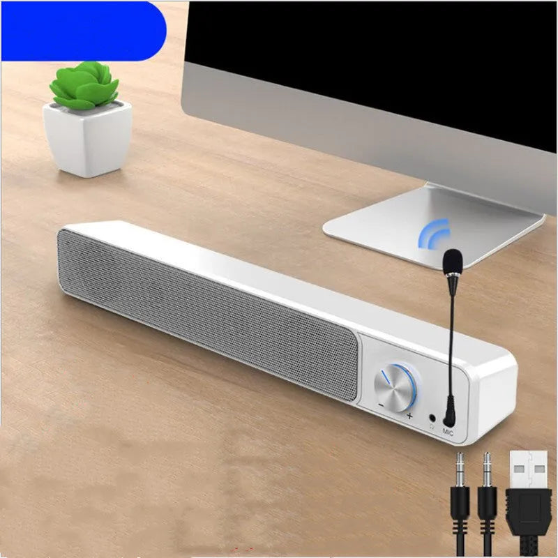 Black and white wired desktop computer speakers with ABS PC casing on a desk