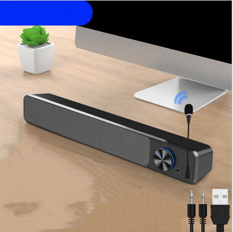 Black and white wired desktop computer speakers with ABS PC casing on a desk