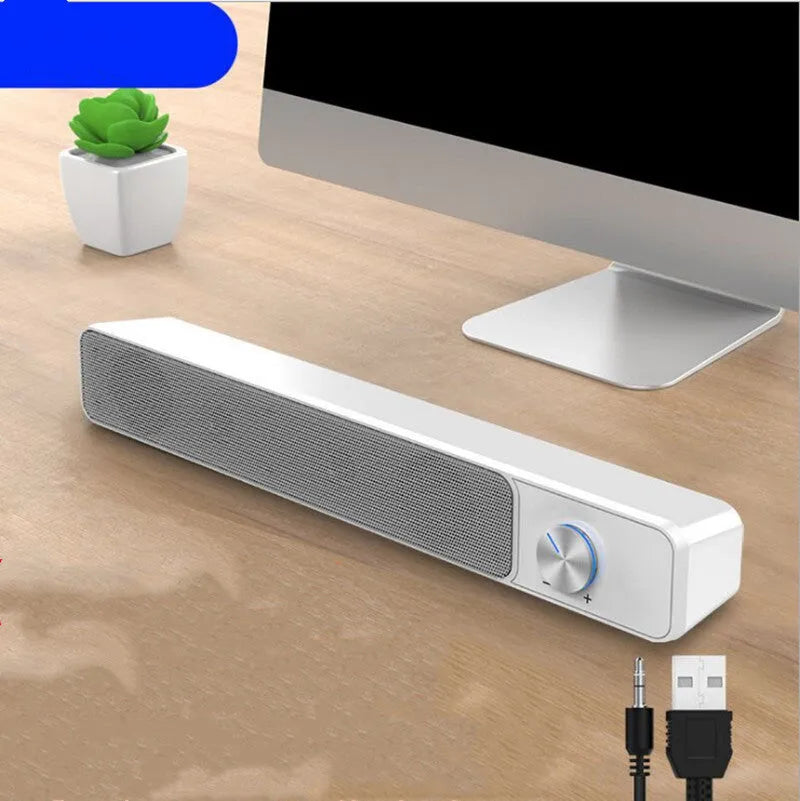 Black and white wired desktop computer speakers with ABS PC casing on a desk