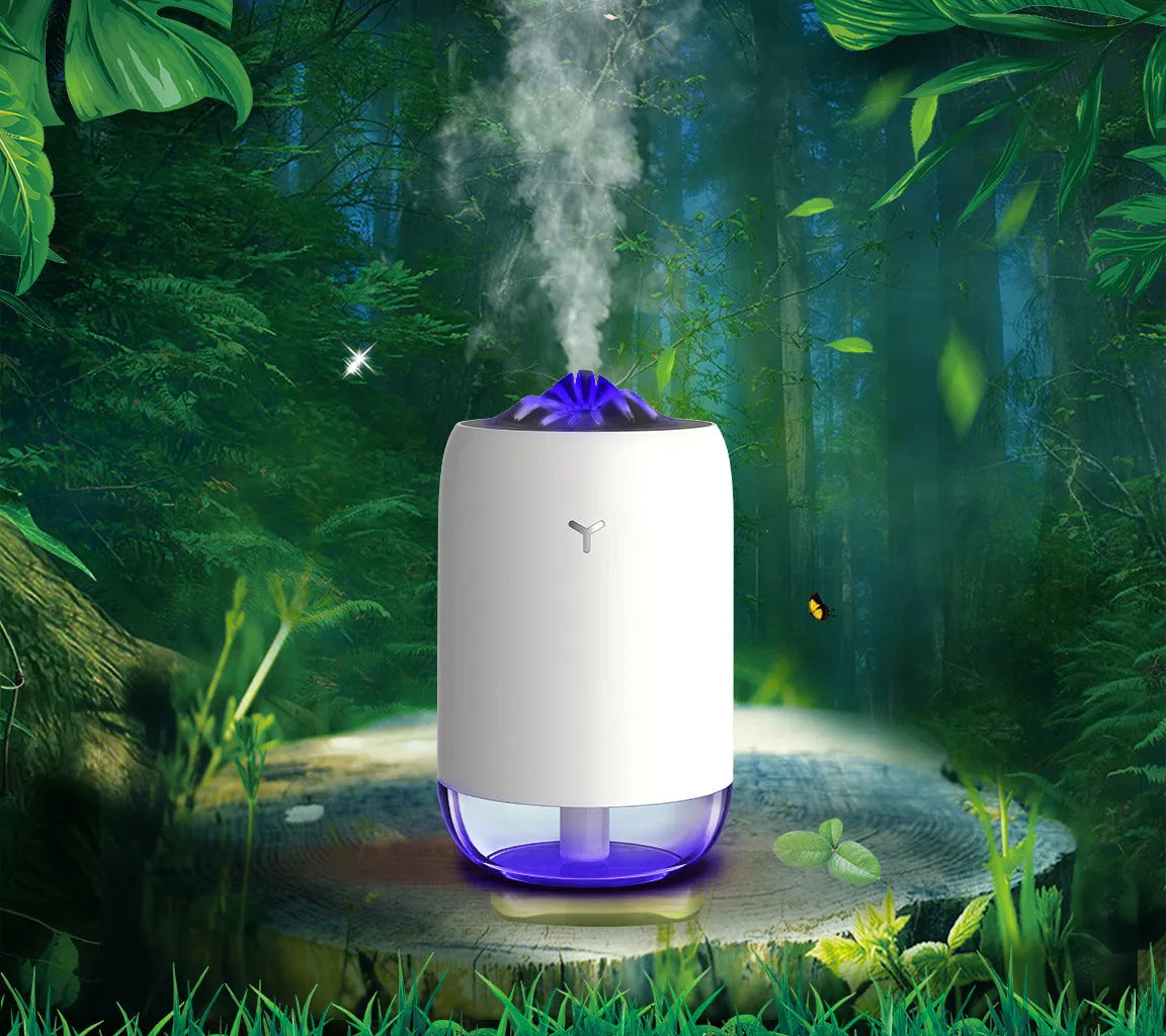 White columnar Magic Flame ultrasonic humidifier with water tank and USB cable on a wooden desk.
