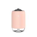 White columnar Magic Flame ultrasonic humidifier with water tank and USB cable on a wooden desk.