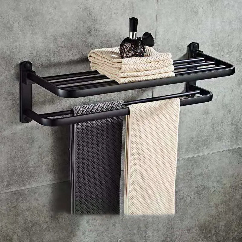 Aluminium two-tier bathroom folding shelf on a white wall, showing optional hooks and perforated surface design.