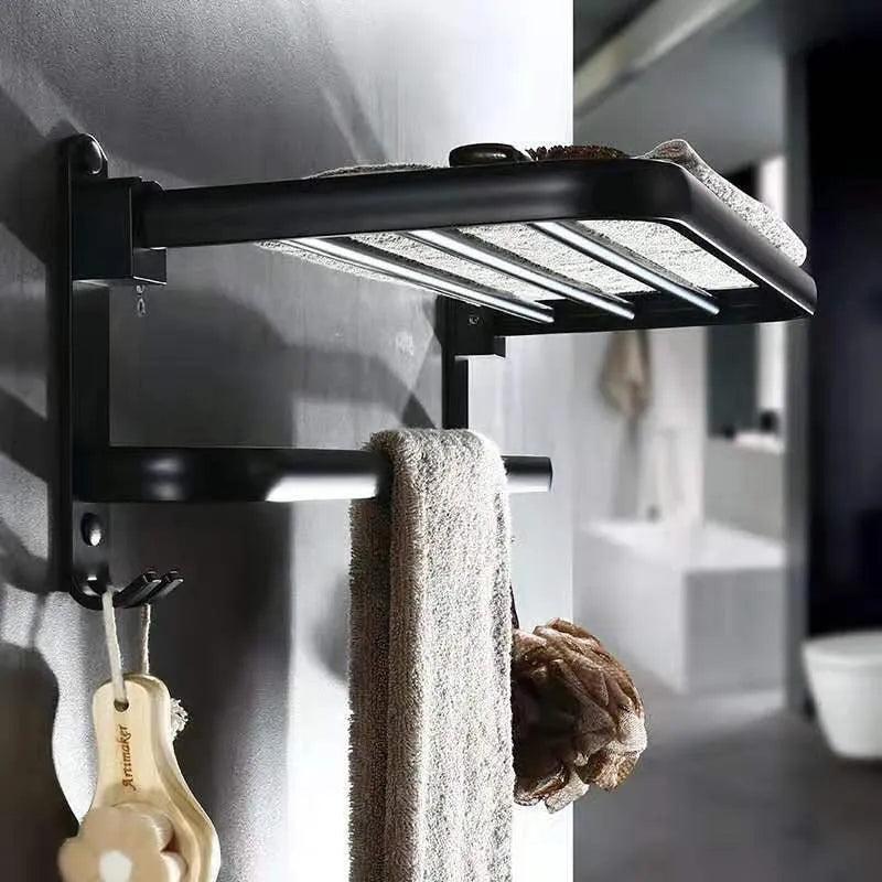 Aluminium two-tier bathroom folding shelf on a white wall, showing optional hooks and perforated surface design.