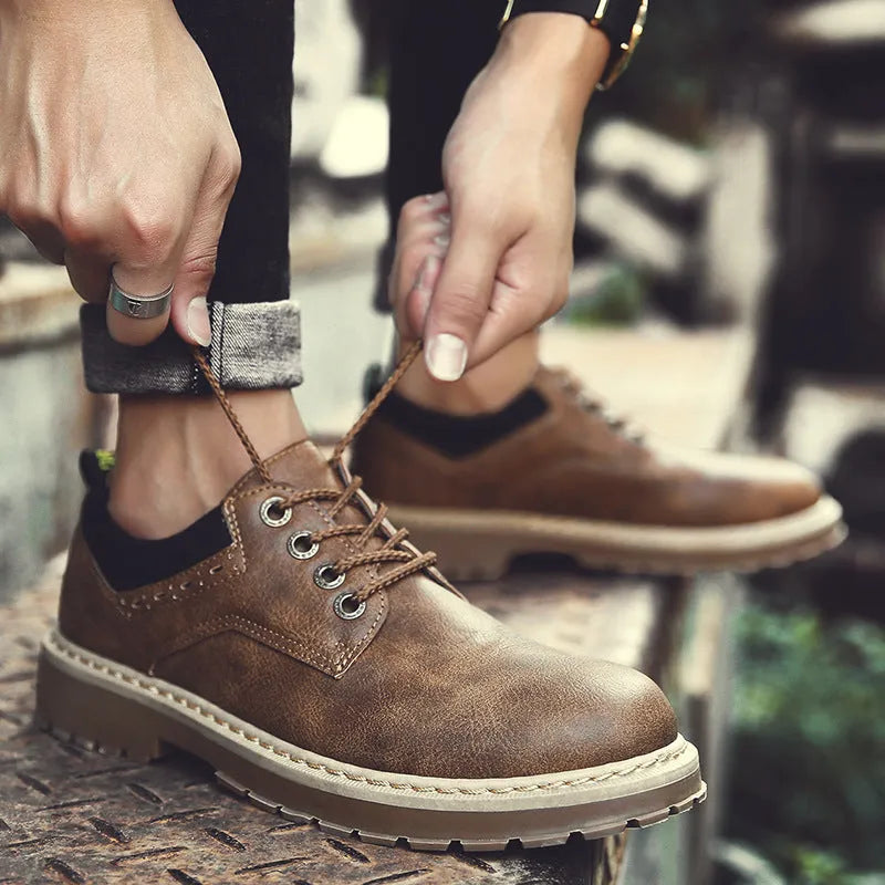 Men's black casual shoes with round toe and front laces on a rubber sole.