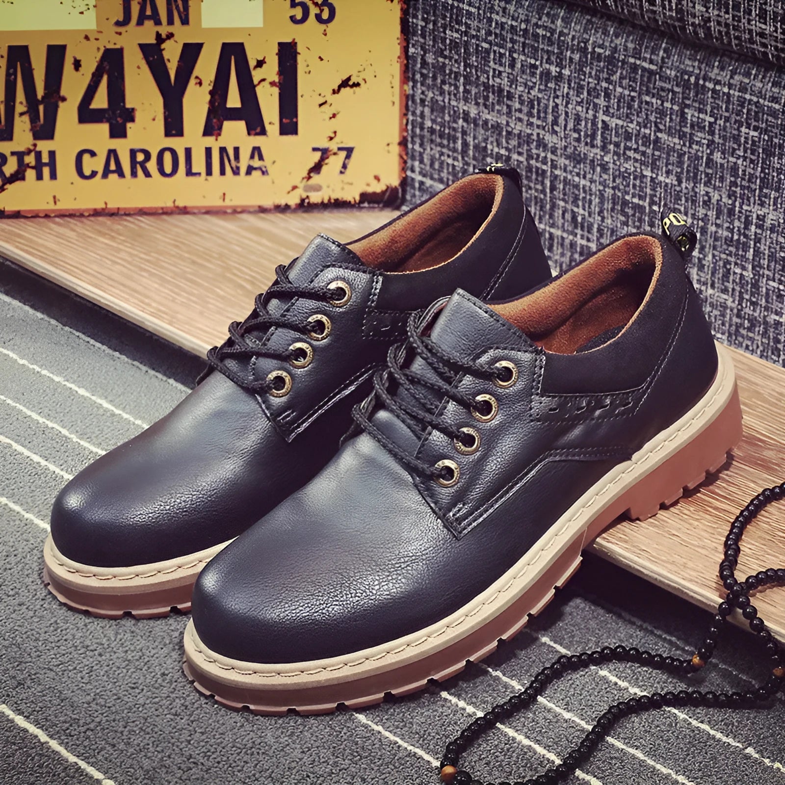 Men's black casual shoes with round toe and front laces on a rubber sole.