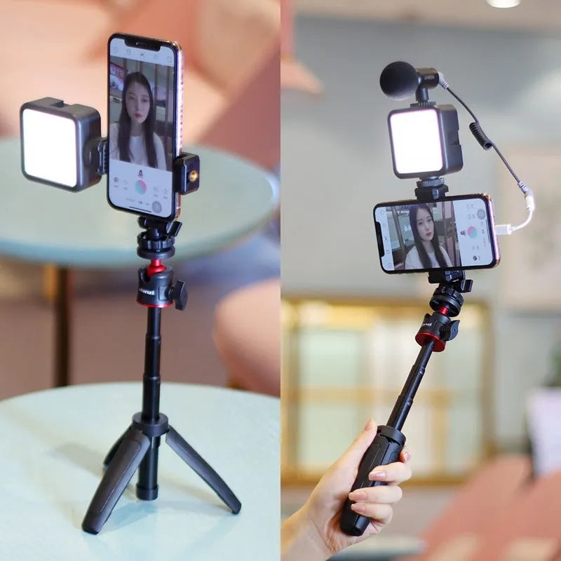 Folded mobile phone vlog bracket with built-in fill light next to a smartphone
