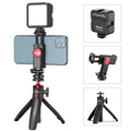 Folded mobile phone vlog bracket with built-in fill light next to a smartphone
