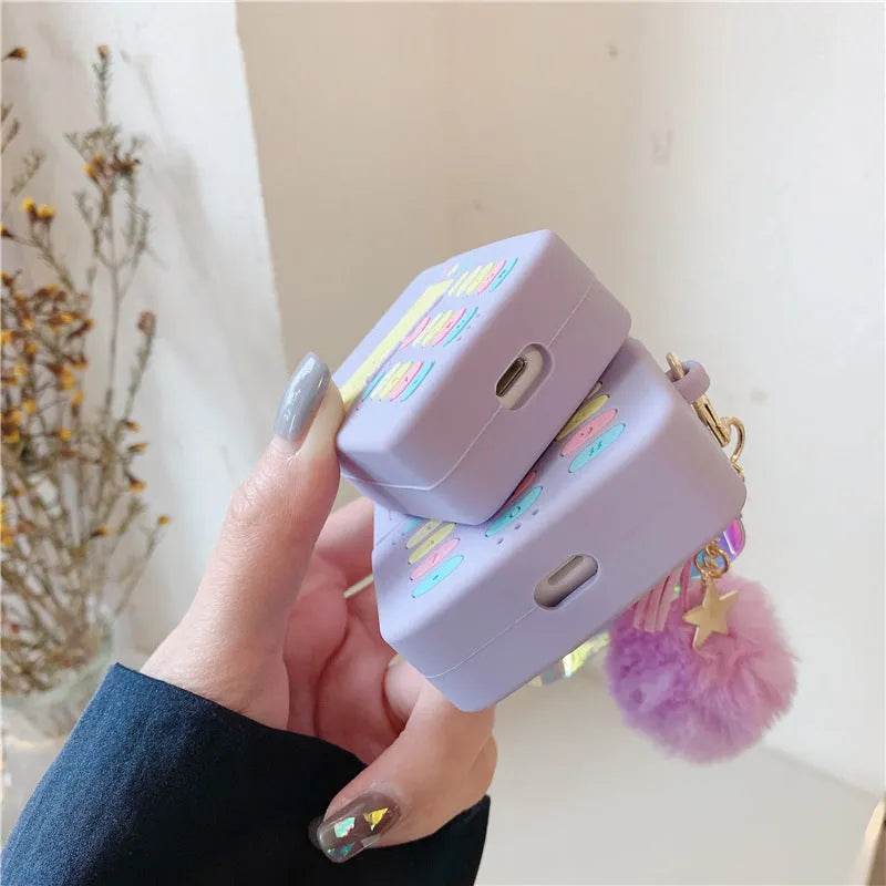 Purple silicone clamshell case for Apple-compatible wireless earphones with fur ball pendant