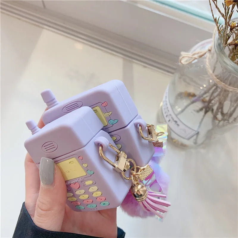 Purple silicone clamshell case for Apple-compatible wireless earphones with fur ball pendant
