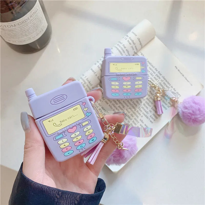 Purple silicone clamshell case for Apple-compatible wireless earphones with fur ball pendant