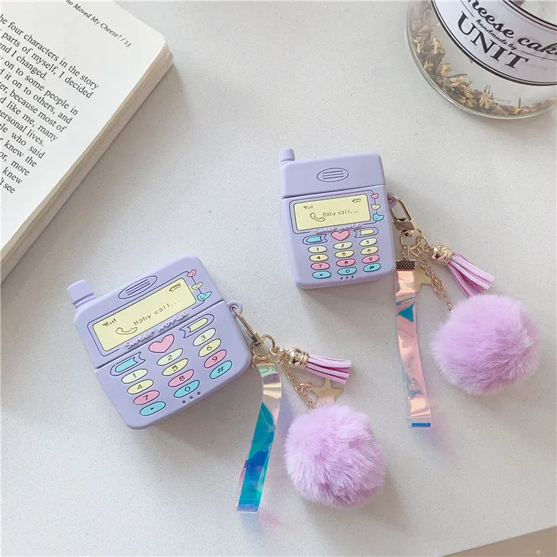 Purple silicone clamshell case for Apple-compatible wireless earphones with fur ball pendant