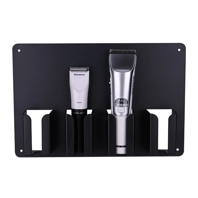 Black plastic wall-mounted frame holding four hair clippers