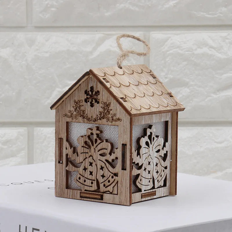 Three handmade wooden house Christmas decorations in natural wood finish with rustic Scandinavian design