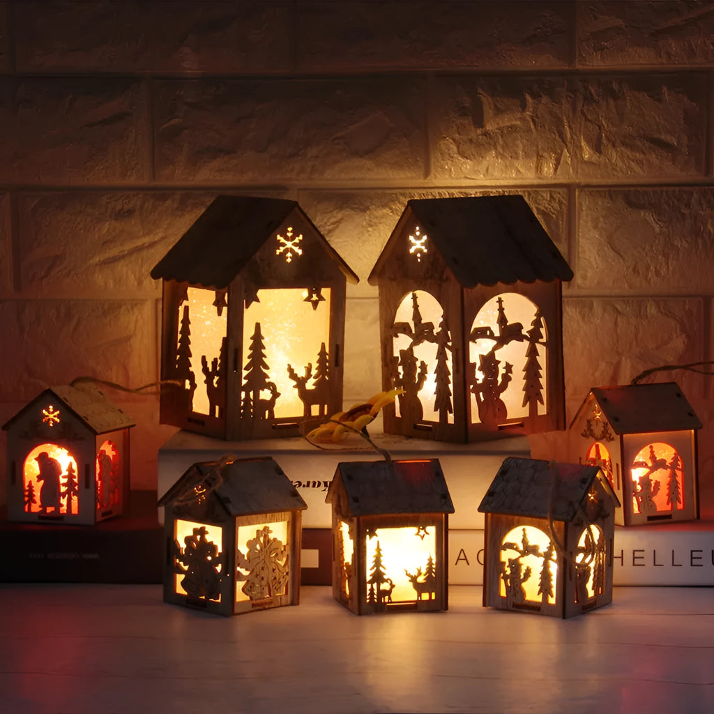 Three handmade wooden house Christmas decorations in natural wood finish with rustic Scandinavian design