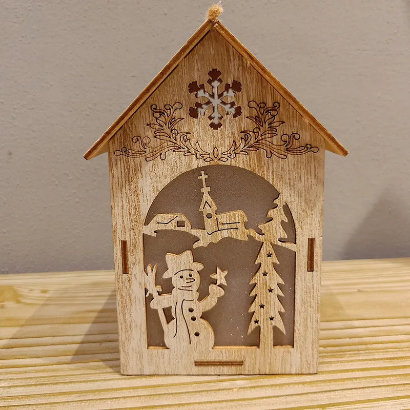 Three handmade wooden house Christmas decorations in natural wood finish with rustic Scandinavian design