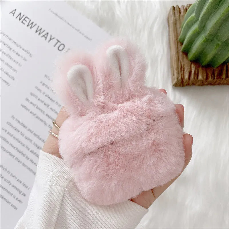 Pink silicone AirPods protective case with plush rabbit ears on charging case